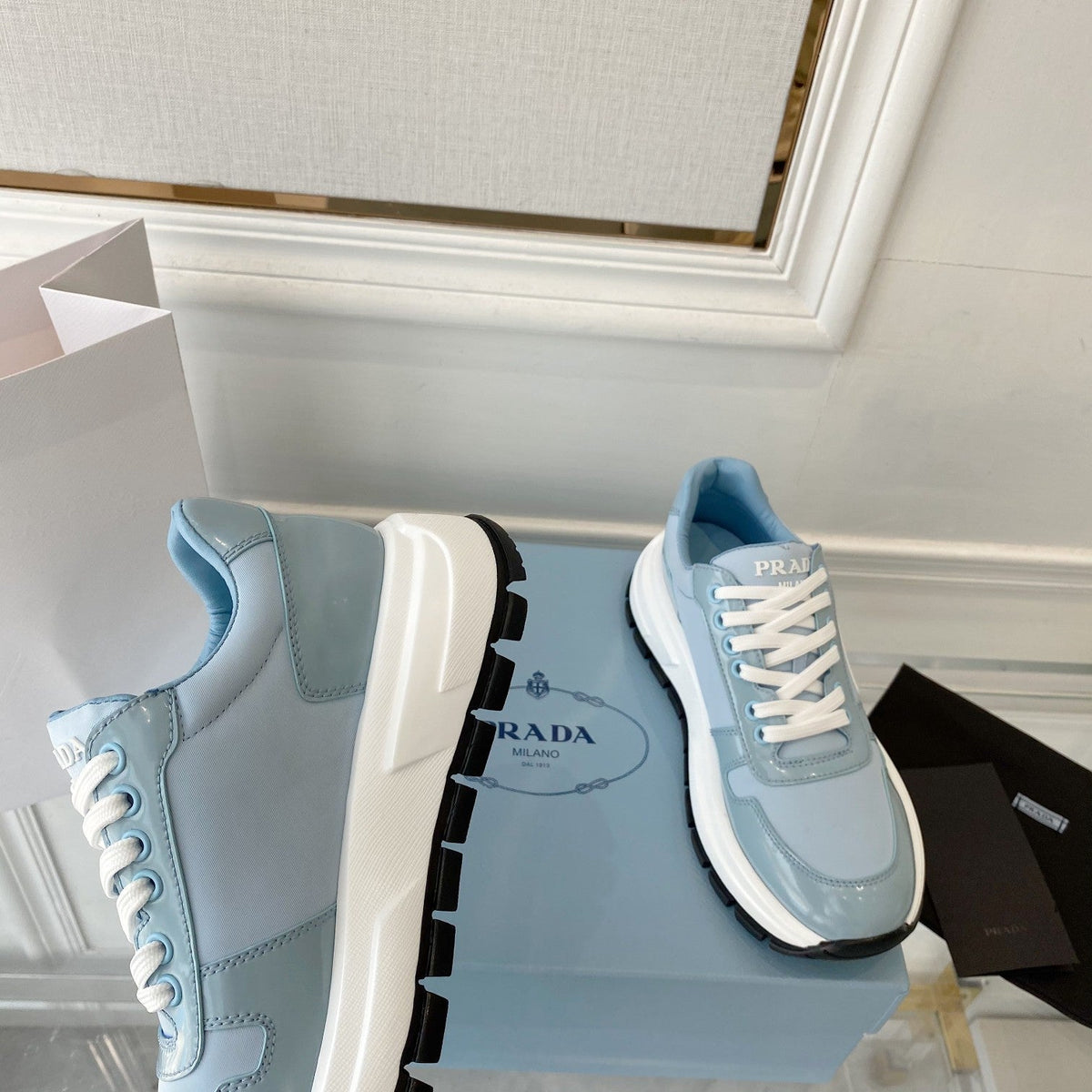 PRADA 25S THICK SOLE SNEAKER IN LIGHT BLUE CALFSKIN AND CANVAS
