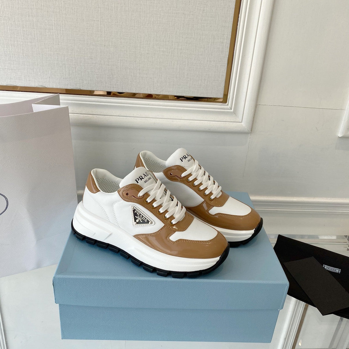PRADA 25S THICK SOLE SNEAKER IN WHITE AND BROWN CALFSKIN