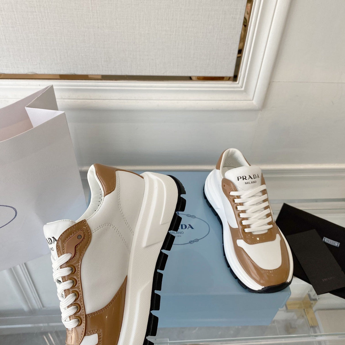PRADA 25S THICK SOLE SNEAKER IN WHITE AND BROWN CALFSKIN