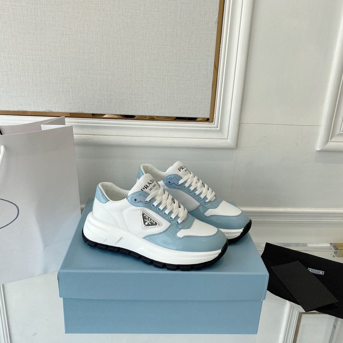 PRADA 25S THICK SOLE SNEAKER IN WHITE AND LIGHT BLUE CALFSKIN