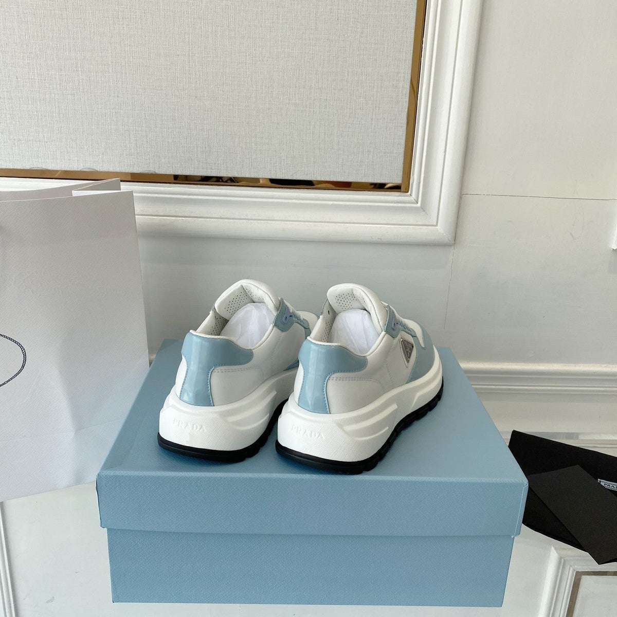 PRADA 25S THICK SOLE SNEAKER IN WHITE AND LIGHT BLUE CALFSKIN