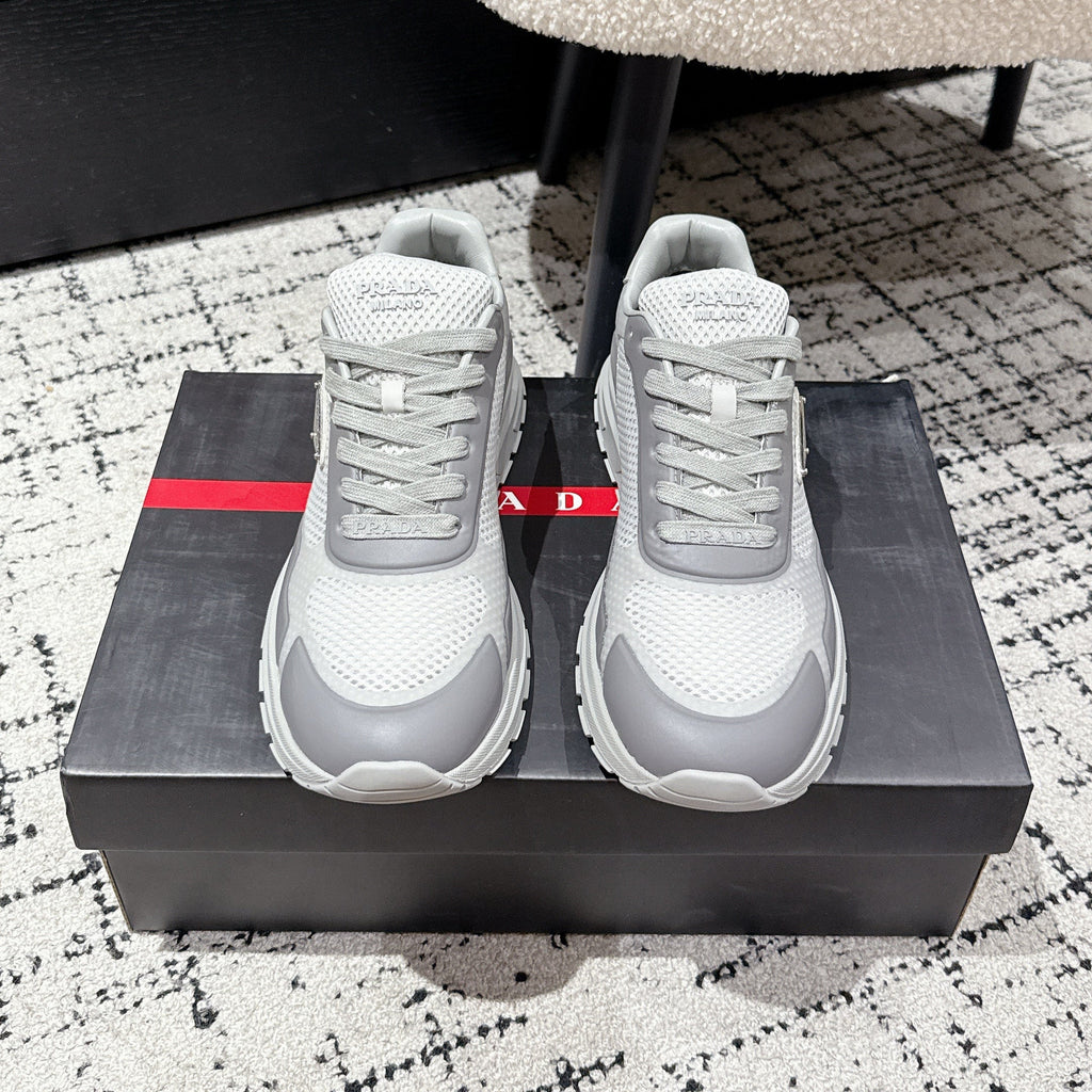 PRADA 25S MEN SNEAKERS IN GRAY AND WHITE CANVAS