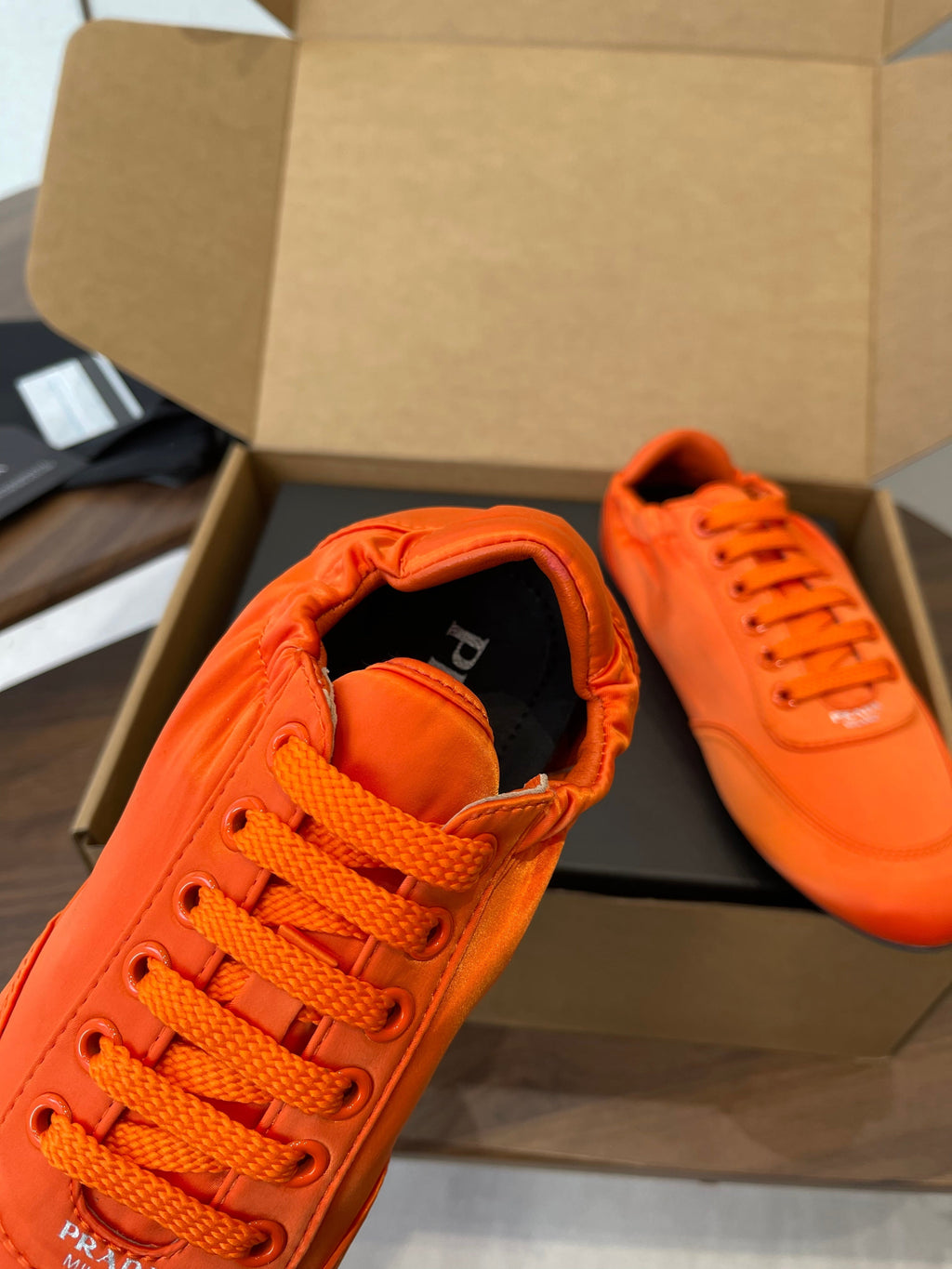 PRADA 25S SNEAKER IN ORANGE SILK