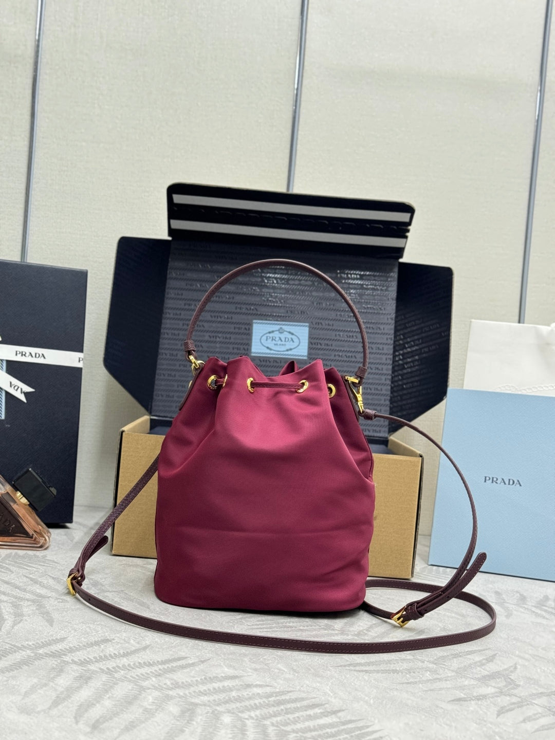 PRADA 25S DUET BUCKET BAG 23 IN BURGUNDY RE-NYLON GOLD HARDWARE